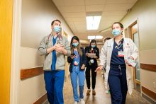 Internal medicine residents walking together in a hallway of University Hospital
