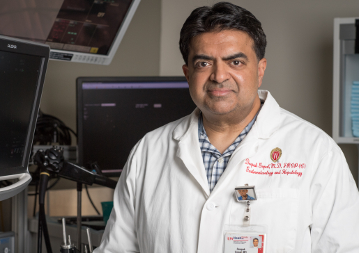 Gastroenterology faculty member Dr. Deepak Gopal stands in front of equipment in a procedure room