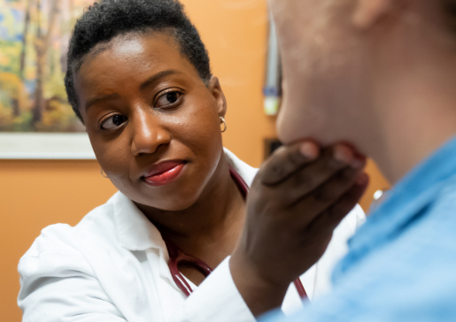 Dr. Lisa Jones touches a patient's face as a part of an exam in the gastroenterology clinic