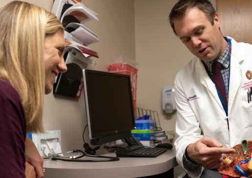 Dr. John Rice uses an anatomical model of a liver to educate a patient