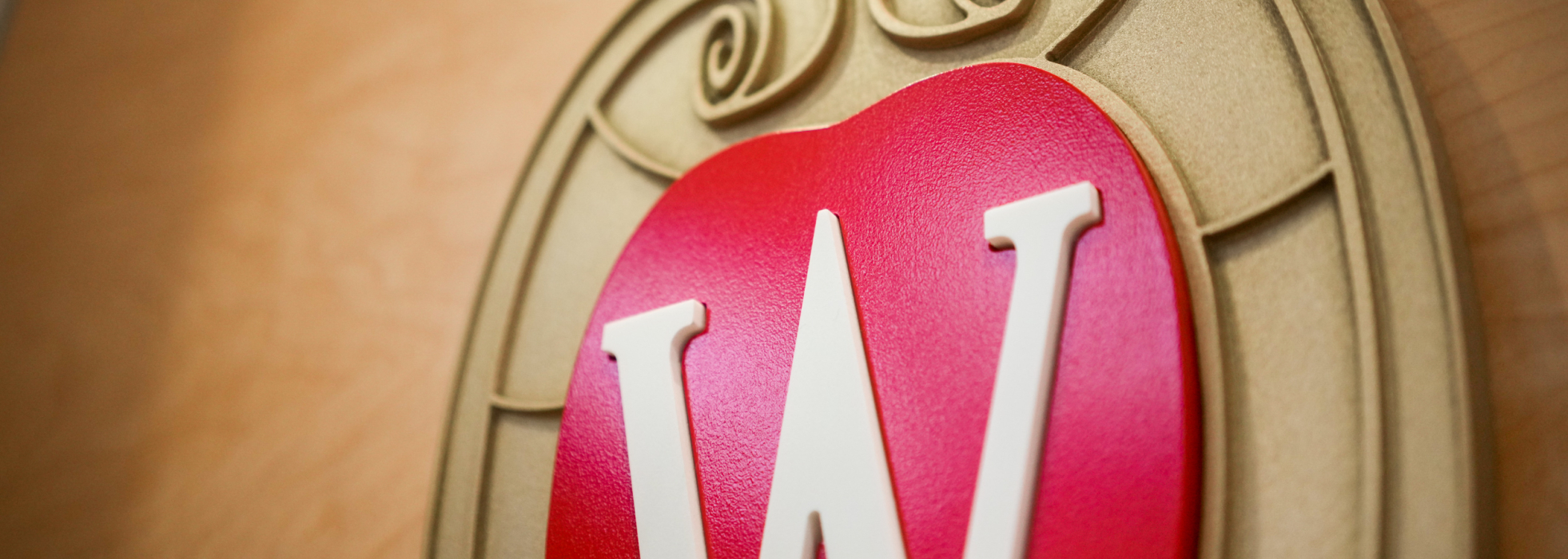 Closeup of UW crest on an interior wall at the University of Wisconsin School of Medicine and Public Health