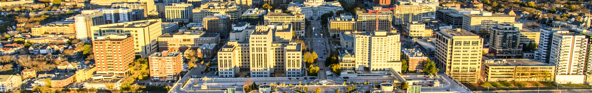 An aerial photo of Madison, with Lake Mendota in the background, the State Capitol and downtown Madison in the mid-ground, and Monona Terrace and Lake Monona in the foreground.