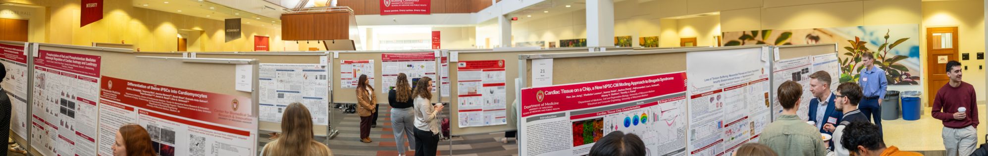Panographic photo of a poster session in the HSLC atrium during the Department of Medicine's Research Day