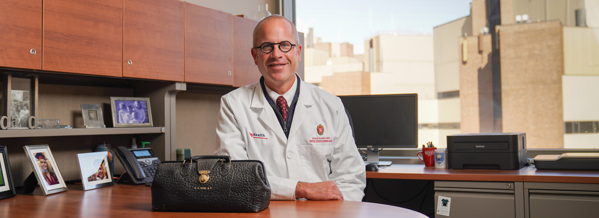 Dr. David Andes in his office with Dr. William A. Craig's medical bag on his desk