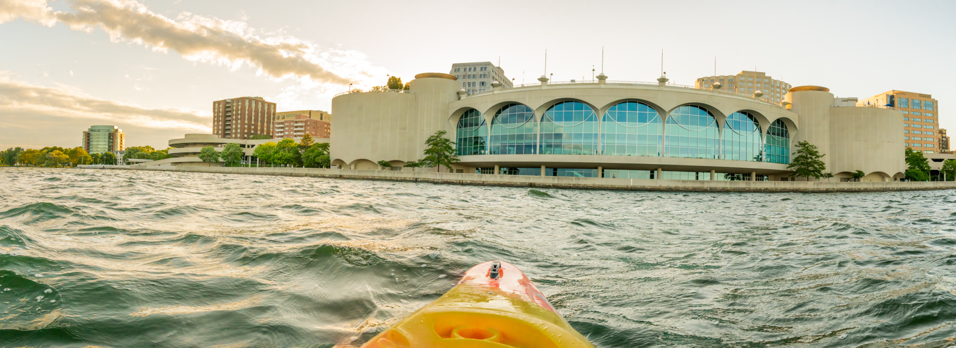 View from kayak paddling across Lake Monona in Madison, with the Monona Terrace convention center in the background