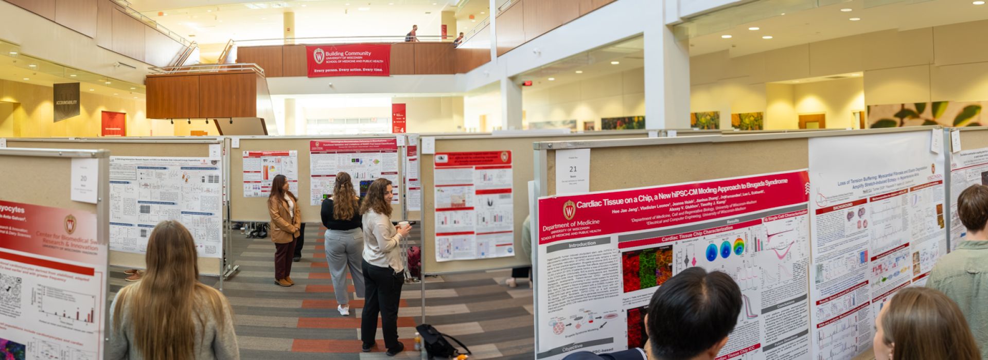 Panographic photo of a poster session in the HSLC atrium during the Department of Medicine's Research Day