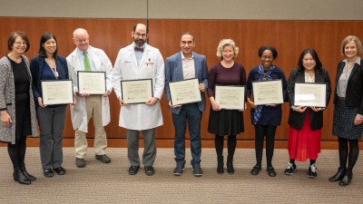 Photo of the 2023 DOM Education Award winners, left to right, between department chair Lynn Schnapp, MD (far left) and Laura Zakowski, MD (far right): Tiffany Lin, MD; Mark Reichelderfer, MD; Zachary Goldberger, MD, MS; Sandesh Parajuli, MD; Laurel Romer, MD; Christine Sharkey, MD; Andrea Schnell, MD.