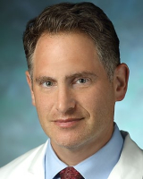 portrait of Dr. Daniel Brotman wearing his white coat