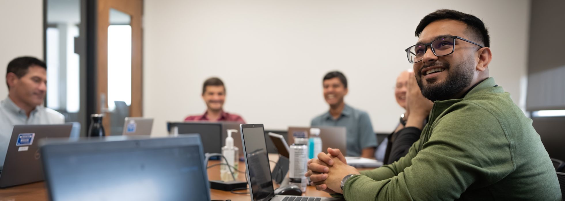 Clinical informatics people in a conference room.