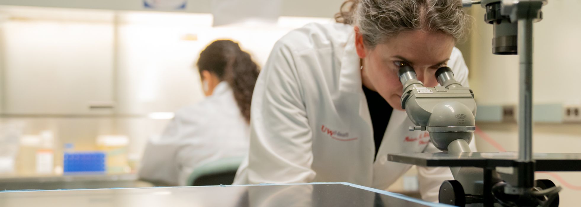 Woman looking into microscope
