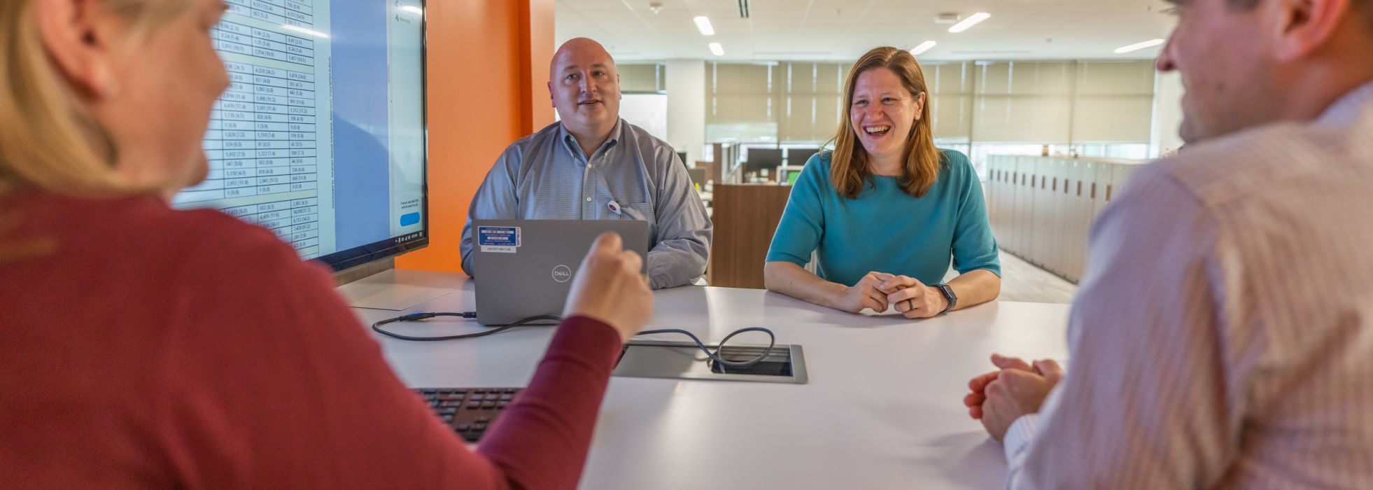 Clinical Informatics Fellowship faculty sitting at a table talking