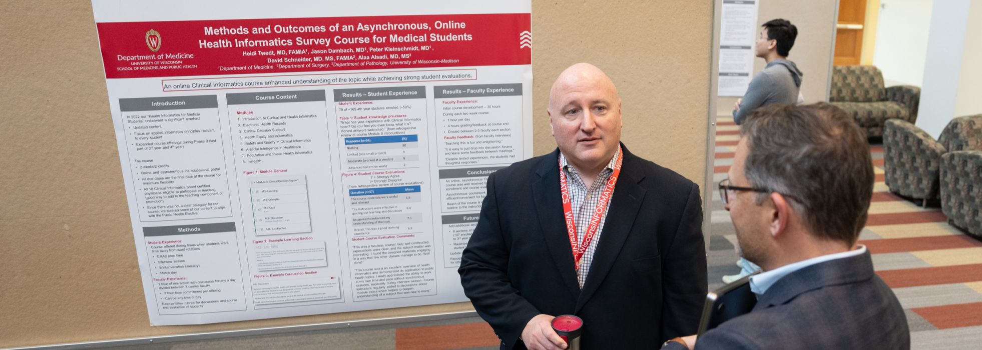 Dr. Jason Dambach discusses a poster on a health informatics course for medical students