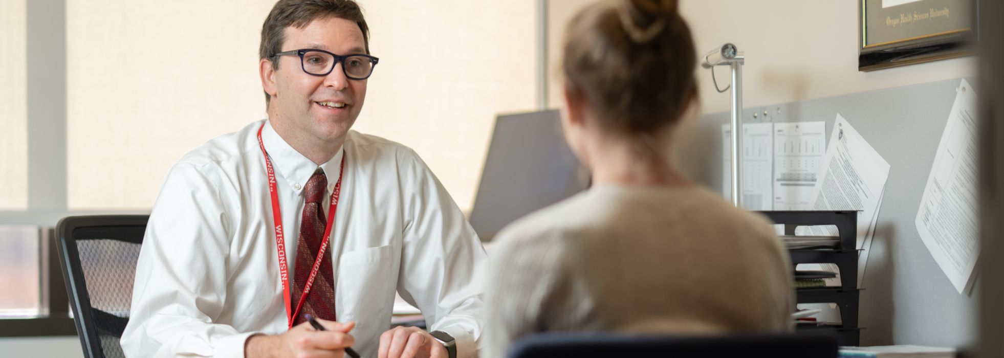 Dr. Ed Vasilevskis in conversation with a colleague