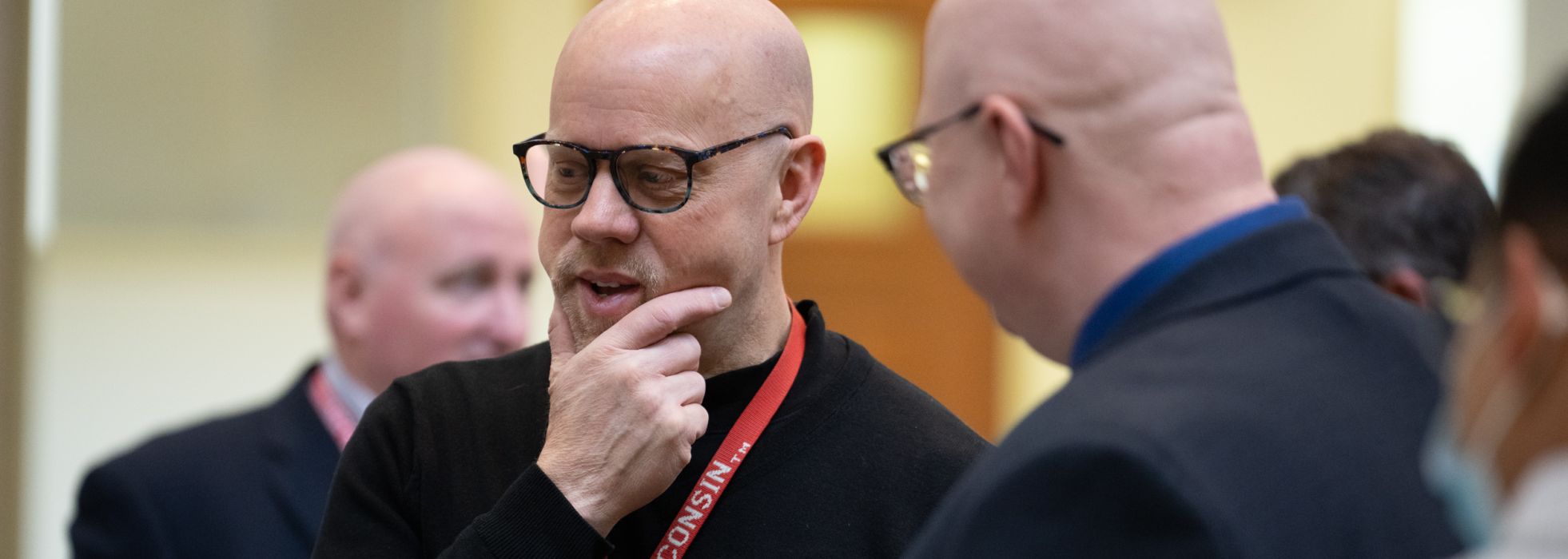 Dr. David Kunstman talks with a colleague at the WisconsINFORMATICS conference 