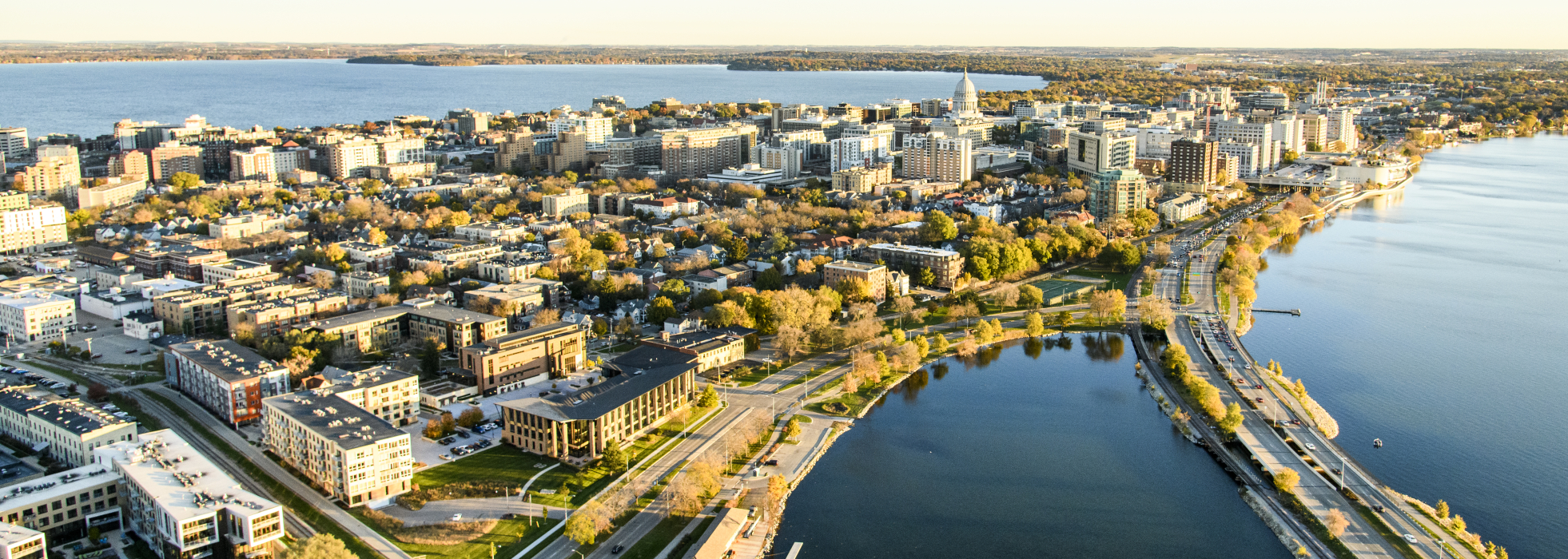 The downtown Madison Isthmus and the Wisconsin State Capitol, along with Monona Bay and John Nolen Drive, are pictured in an early morning aerial taken from a helicopter on Oct. 23, 2018. (Photo by Bryce Richter /UW-Madison)
