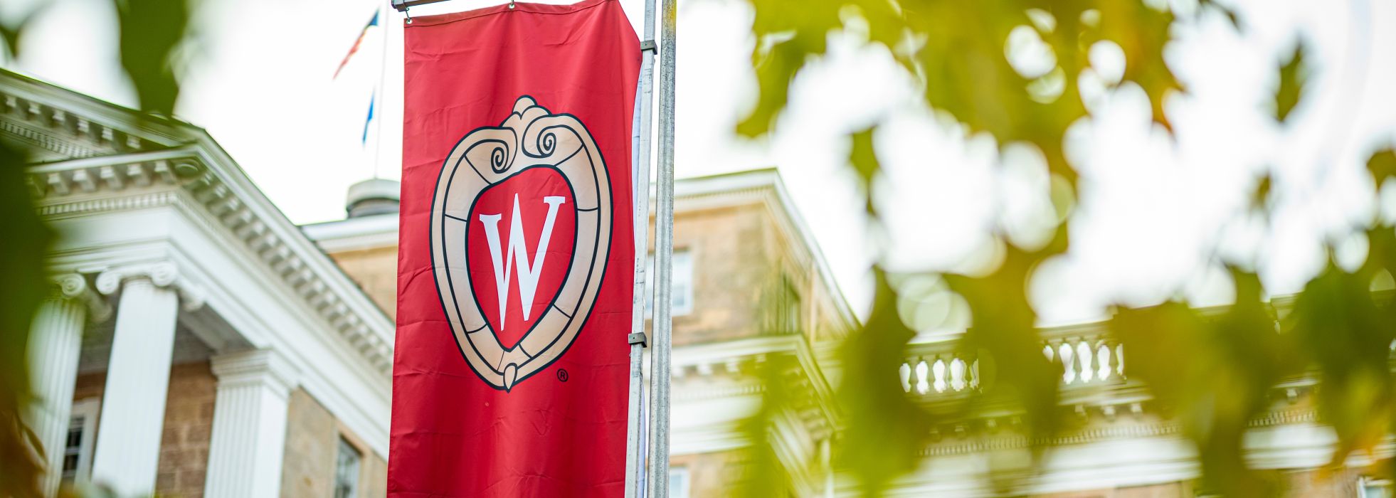 UW flag with crest on Bascom Hill