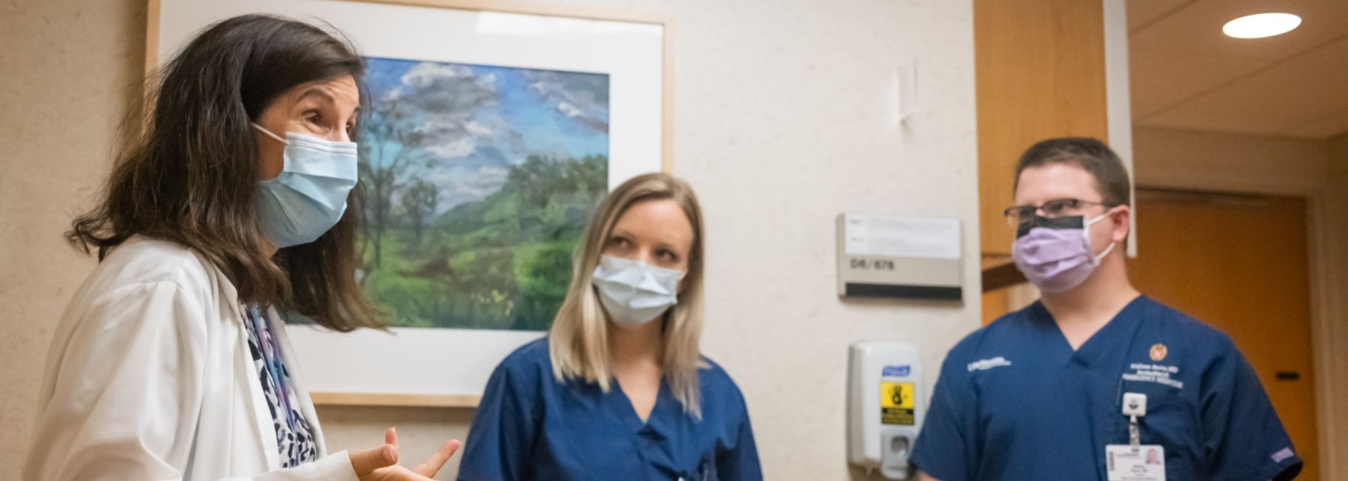 Palliative care faculty talking in hospital hallway