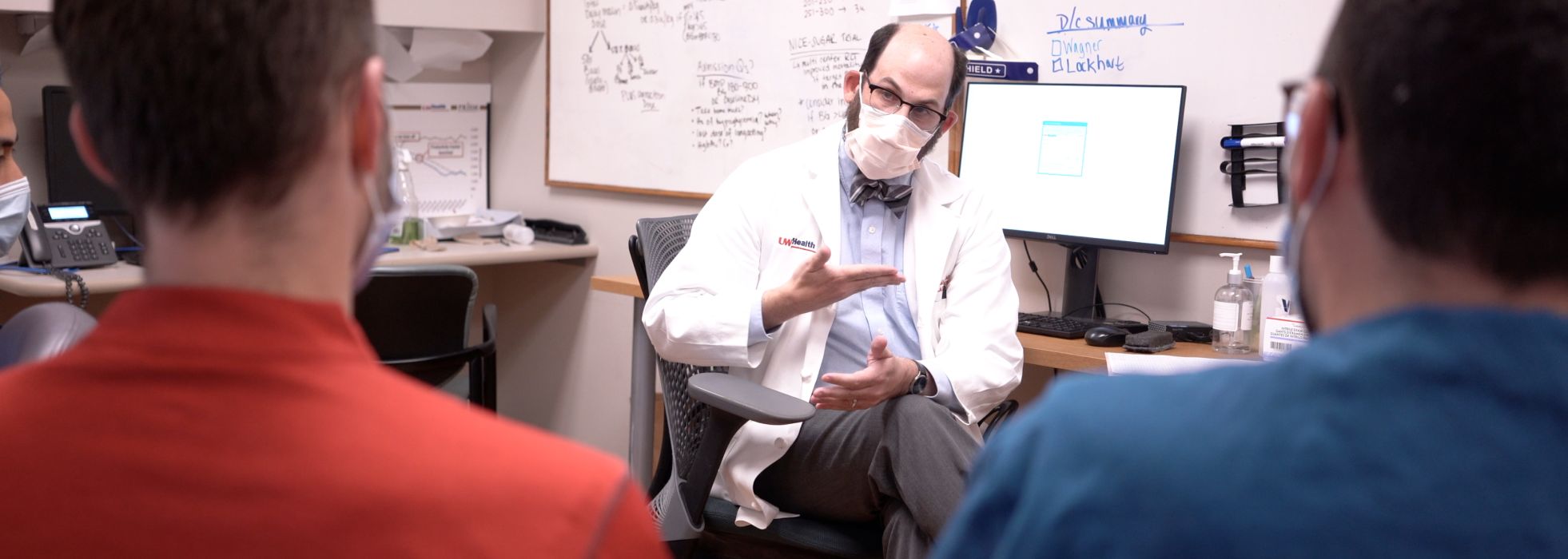 Dr. Zach Goldberger talking to CVD fellows in clinic