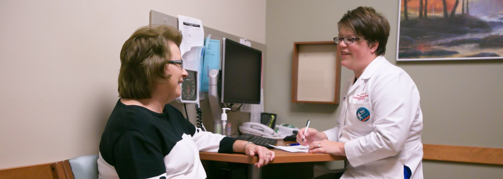 photo of Dr. Noelle LoConte in clinic with a patient