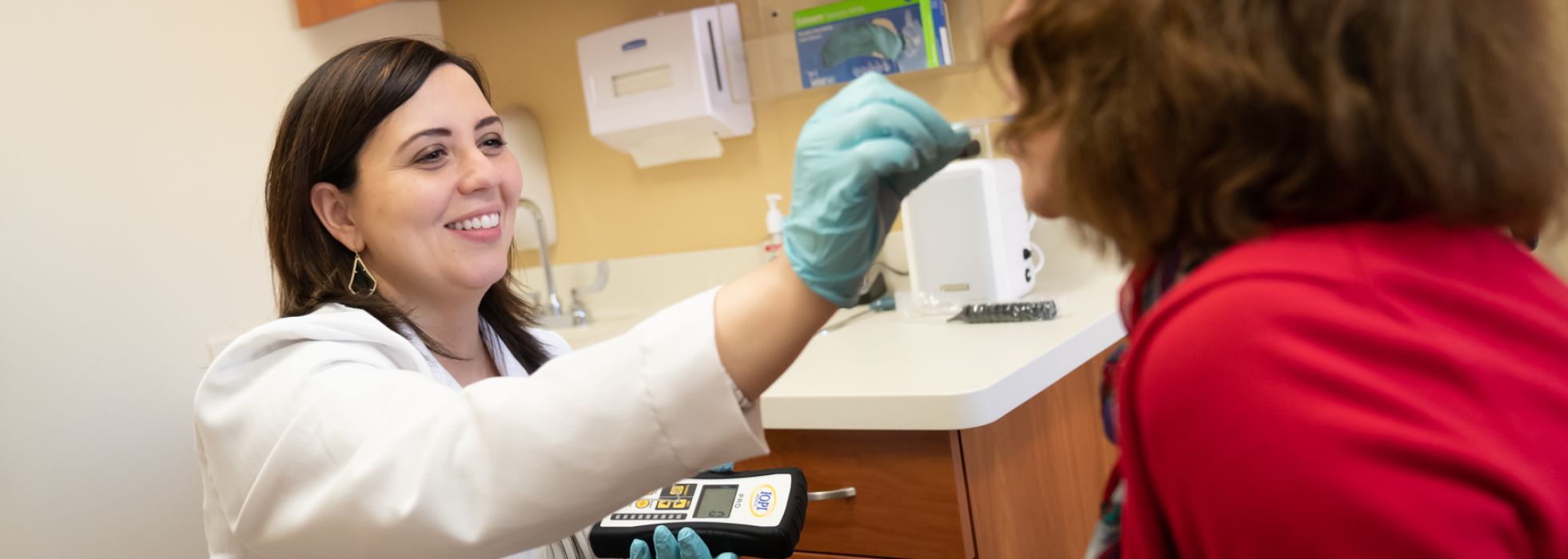 Dr. Nicole Rogus-Pulia with patient in clinic