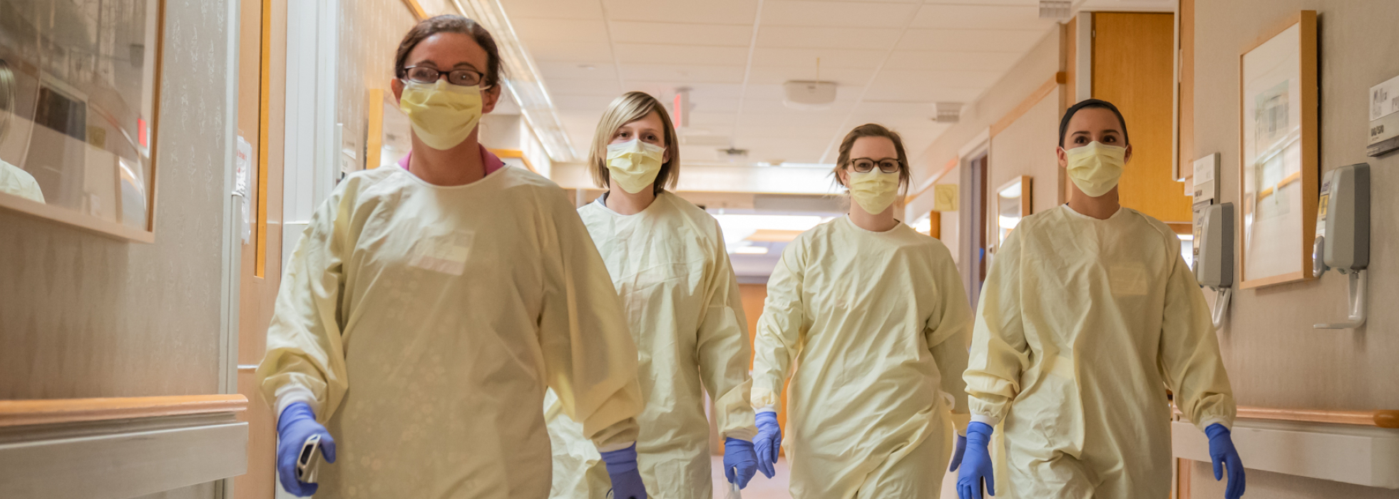 APCC clinicians in gowns and masks at University Hospital