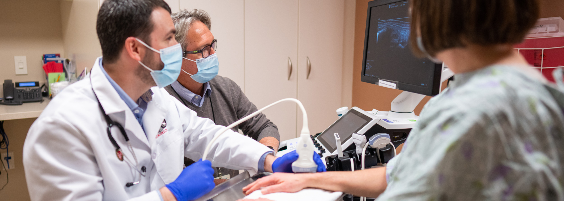 Dr. Jon Arnason teaching musculoskeletal ultrasound skills to a fellow in clinic