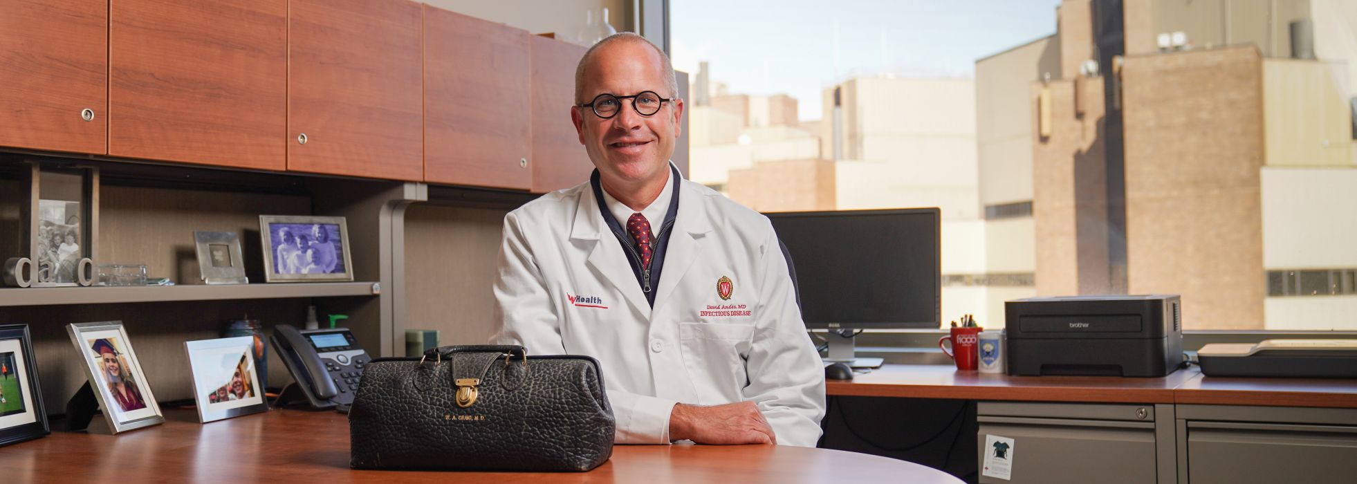 Dr. David Andes in his office with Dr. William Craig's old medical bag