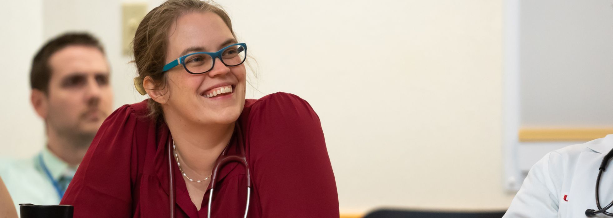 Former UW internal medicine resident Dr. Victoria Gillet smiling during a Morning Report meeting