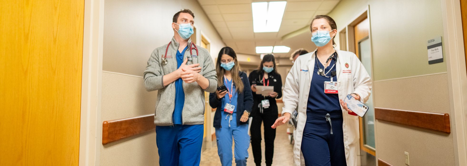 Internal medicine residents walking together in a hallway of University Hospital