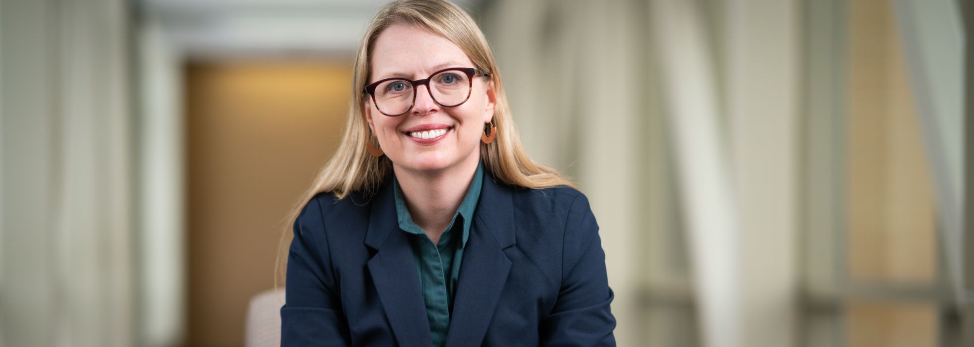 Dr. Christie Bartels in a dark blue jacket at the office 