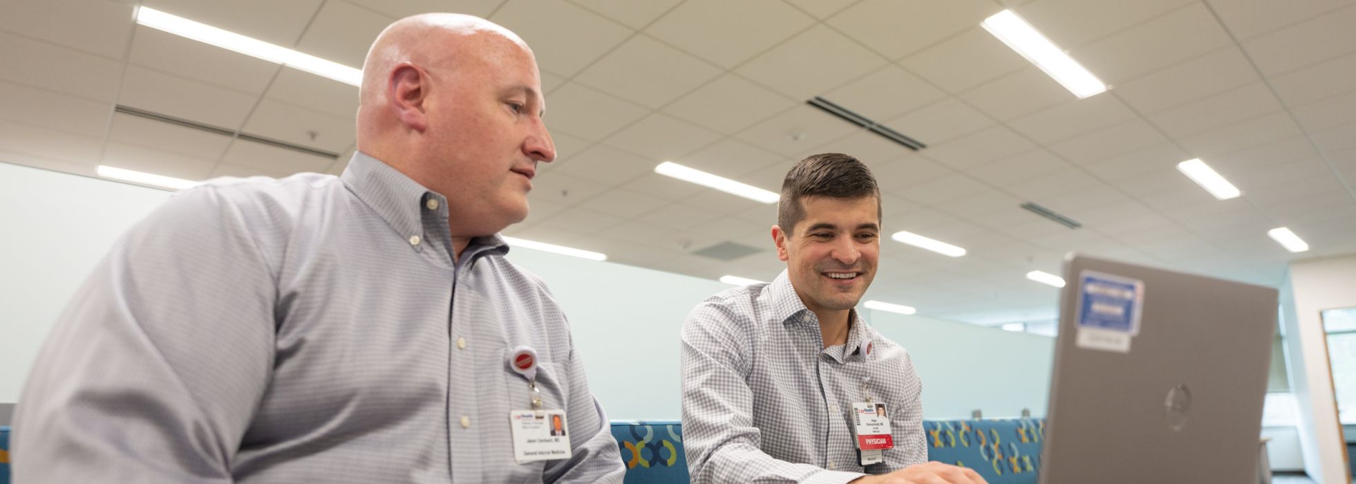 Photo of Clinical Informatics faculty members Dr. Jason Dambach and Peter Kleinschmidt working at a computer