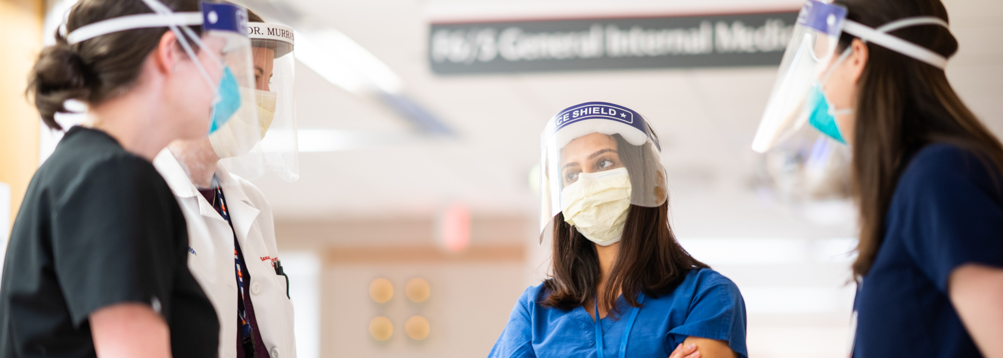 Hospitalists consulting in the hall at University Hospital