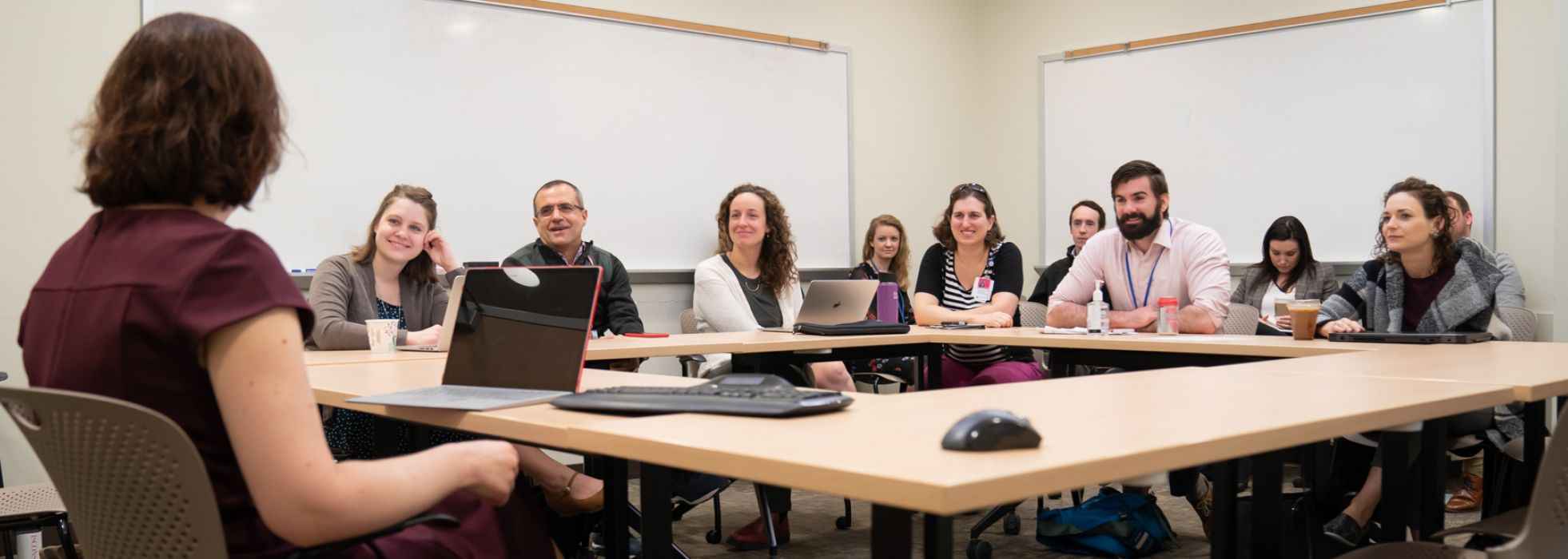 Infectious disease faculty teaching learners at a conference room table