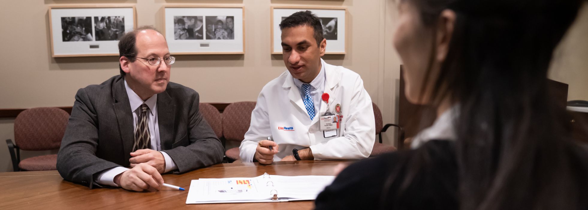 photo of Drs. Brad Astor and Sandesh Parajuli at a table looking at papers
