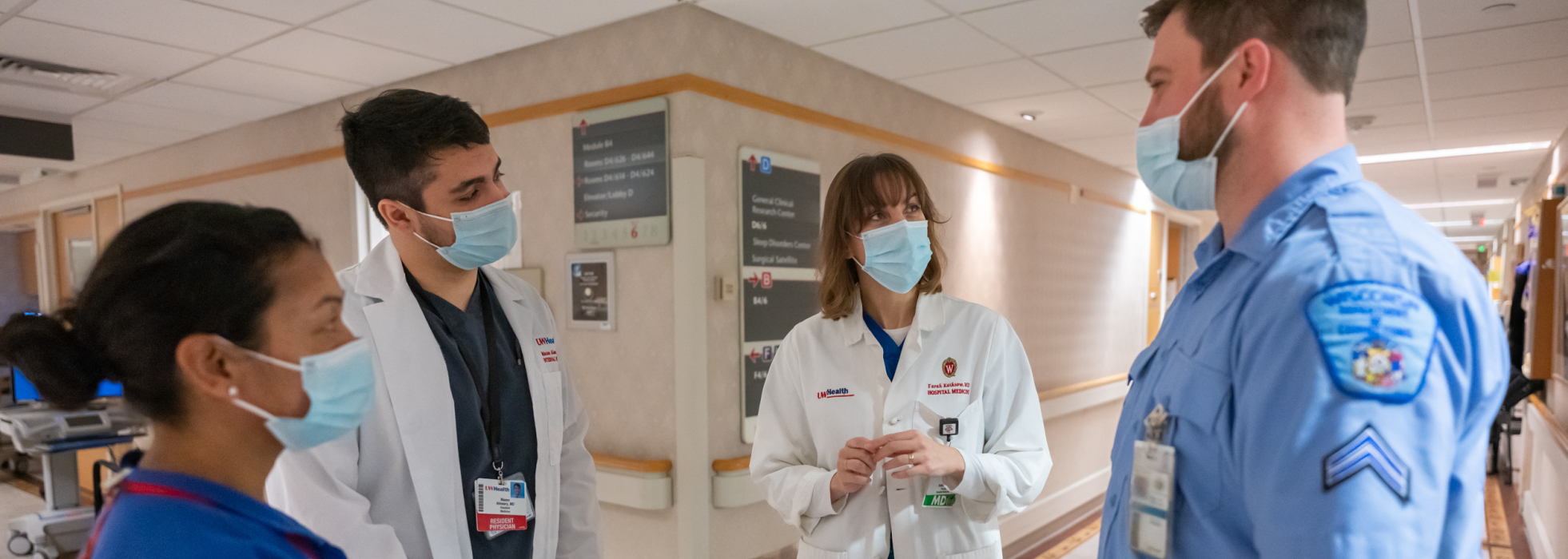 Dr. Farah Kaiksow with learner, medical assistant and corrections officer on the hospital floor