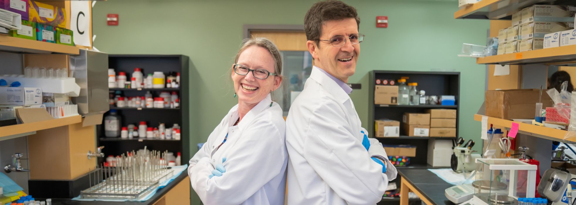 photo of Drs. Rozalyn Anderson and Luigi Puglielli in the lab 