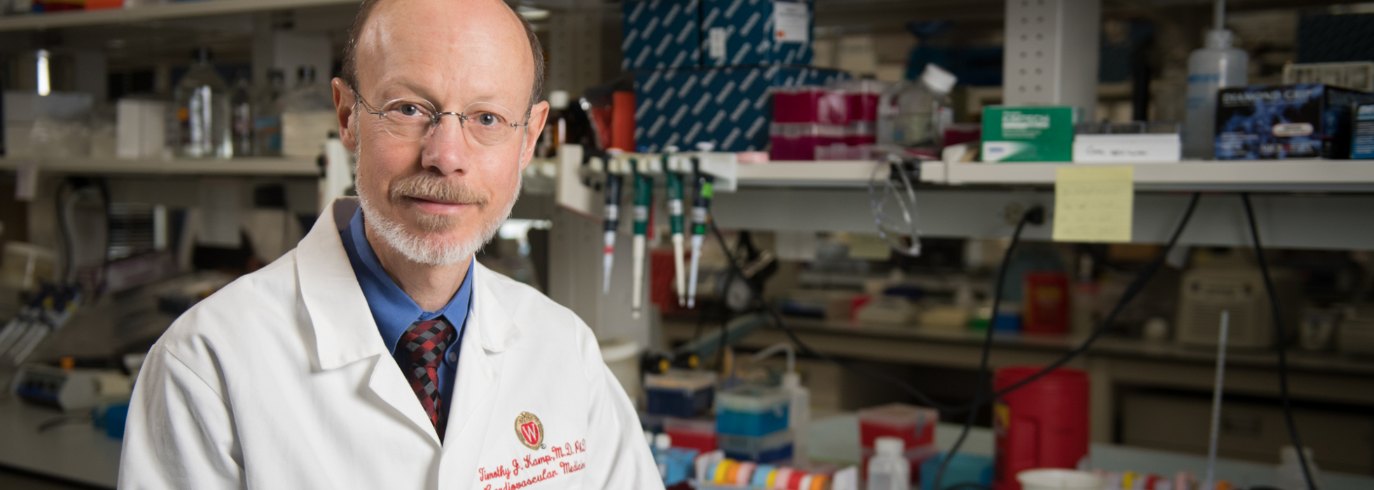 photo of Dr. Tim Kamp wearing white coat in his lab