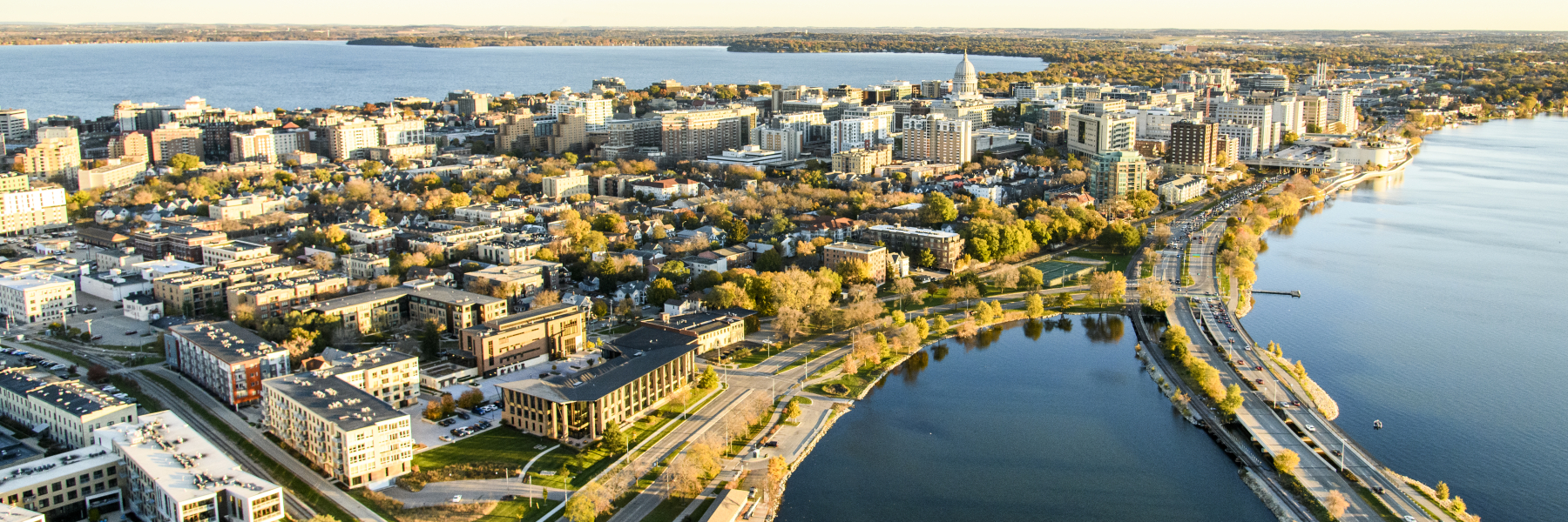 The downtown Madison Isthmus and the Wisconsin State Capitol, along with Monona Bay and John Nolen Drive, are pictured in an early morning aerial taken from a helicopter on Oct. 23, 2018. (Photo by Bryce Richter /UW-Madison)