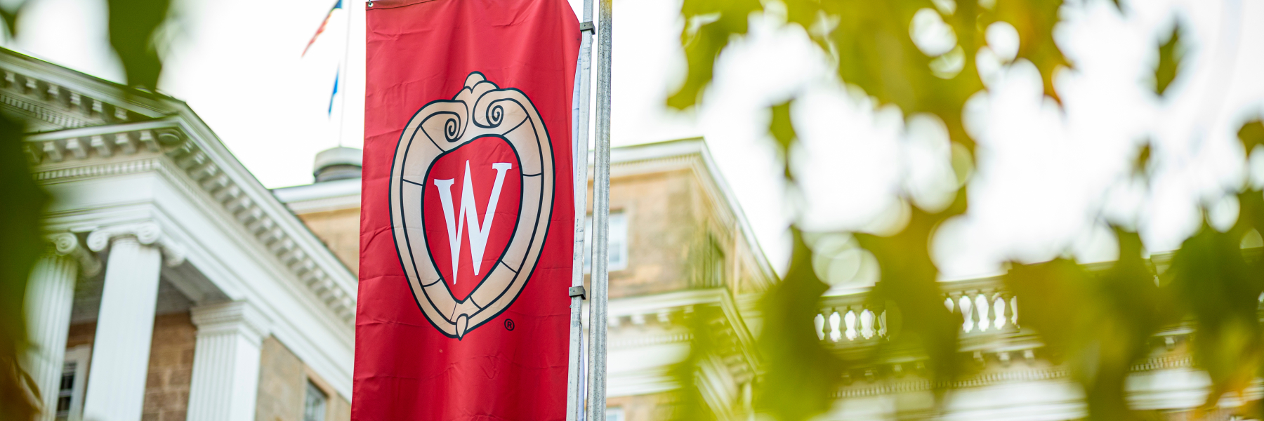 UW flag with crest on Bascom Hill