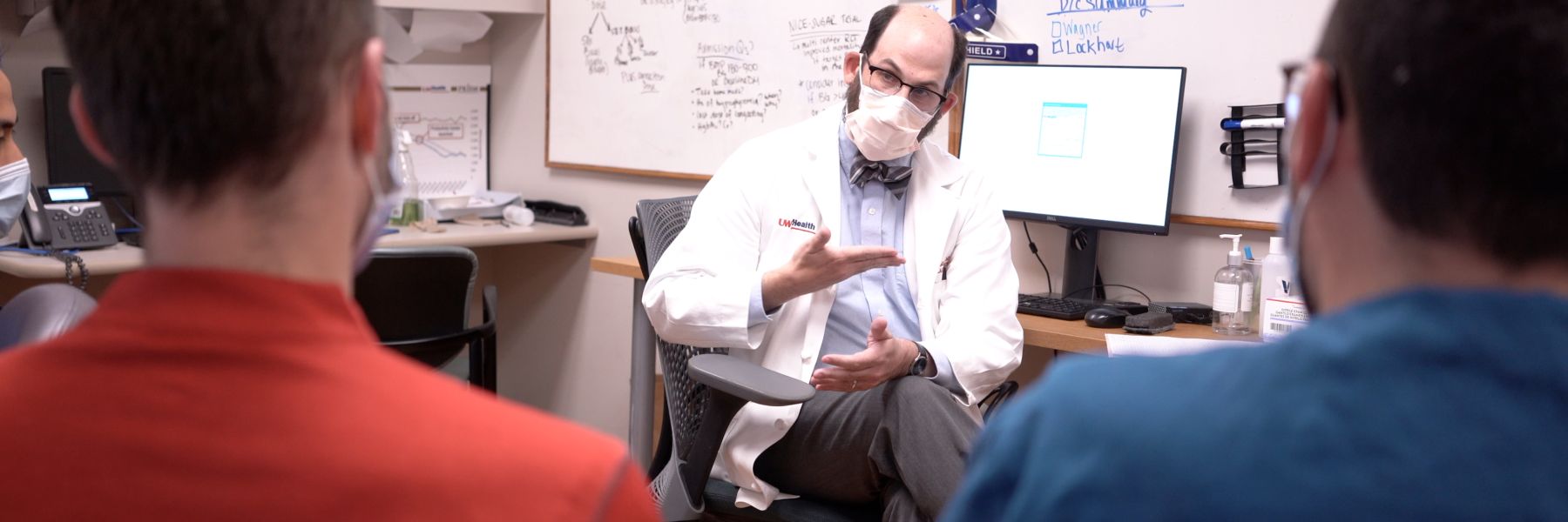 Dr. Zach Goldberger talking to CVD fellows in clinic