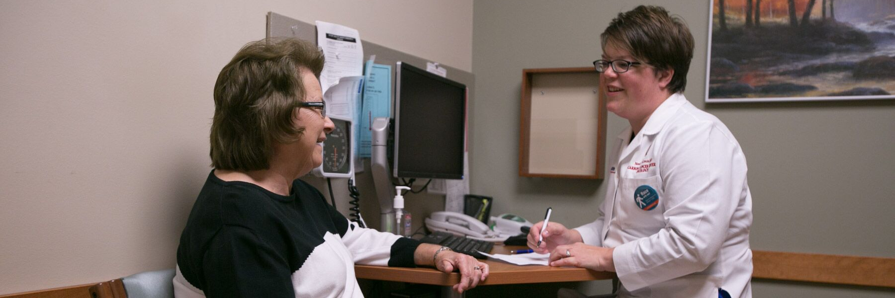 photo of Dr. Noelle LoConte in clinic with a patient