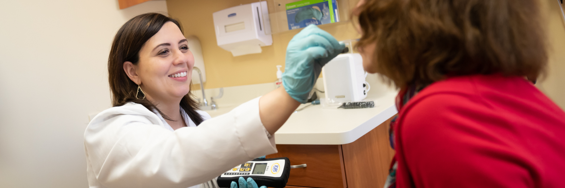 Dr. Nicole Rogus-Pulia with patient in clinic