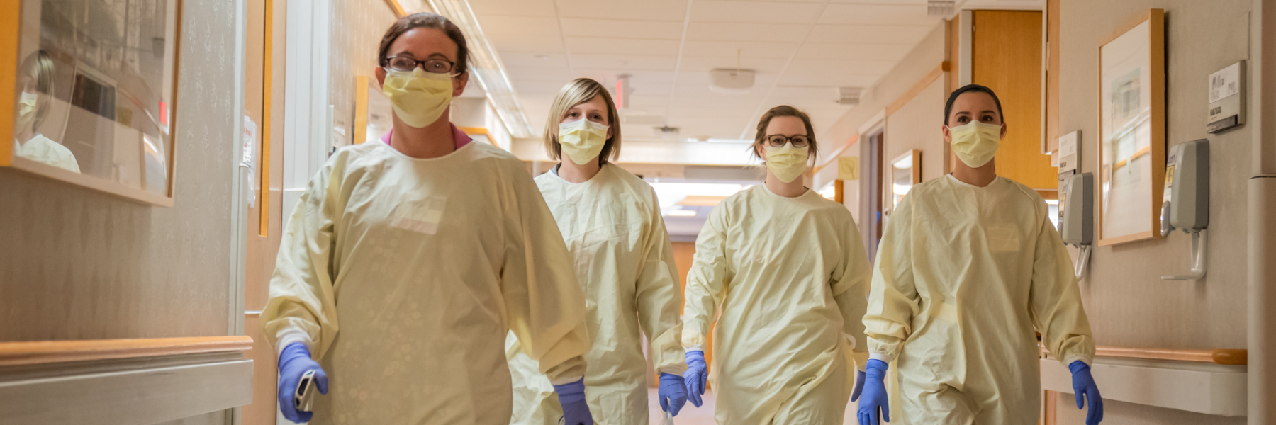 APCC clinicians in gowns and masks at University Hospital