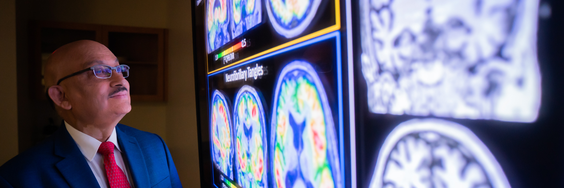 Dr. Sanjay Asthana looking at brain scan images