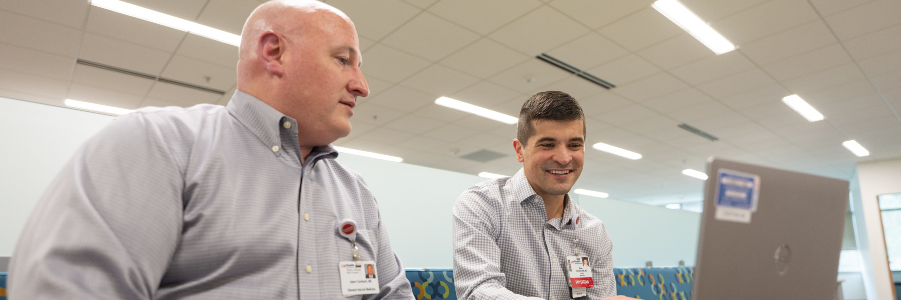 Photo of Clinical Informatics faculty members Dr. Jason Dambach and Peter Kleinschmidt working at a computer