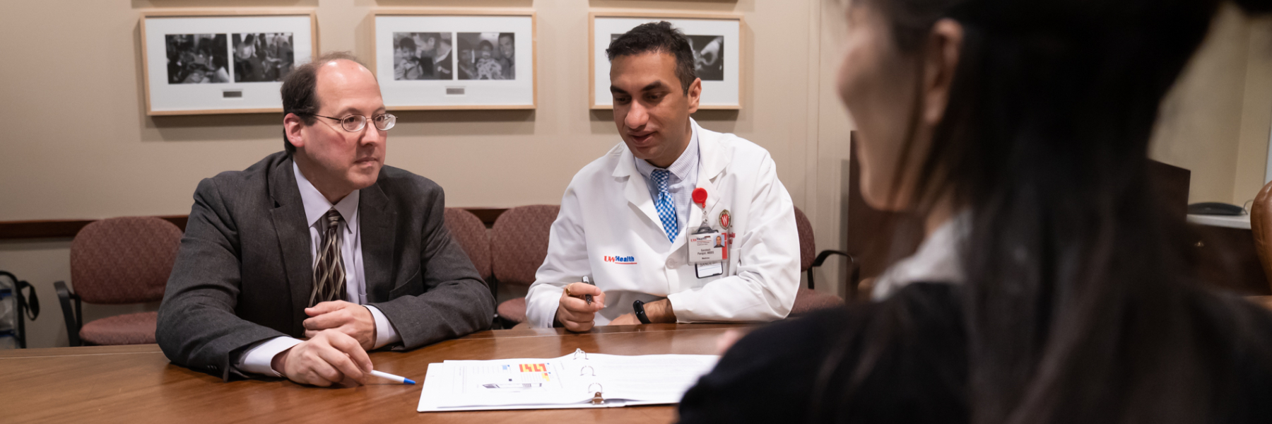photo of Drs. Brad Astor and Sandesh Parajuli at a table looking at papers