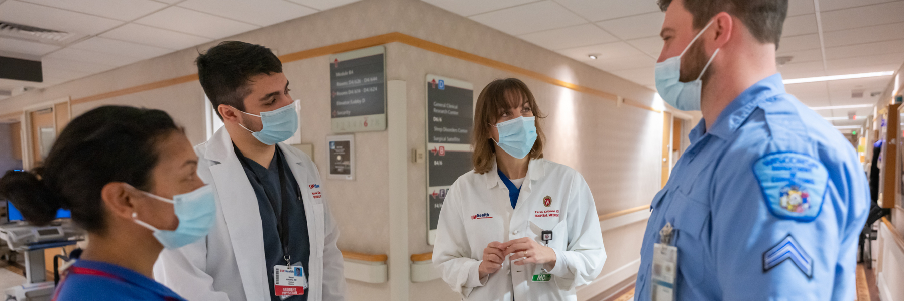 Dr. Farah Kaiksow with learner, medical assistant and corrections officer on the hospital floor