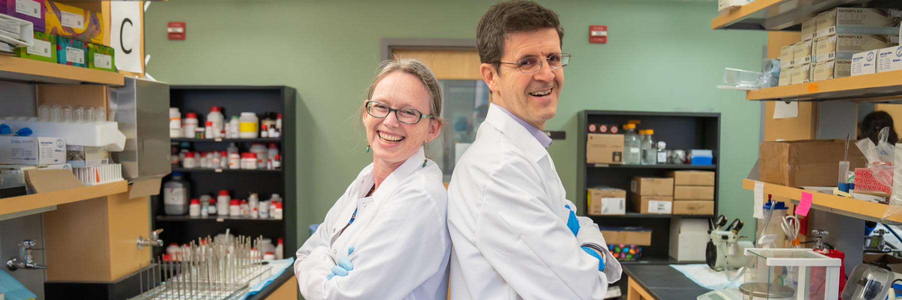 photo of Drs. Rozalyn Anderson and Luigi Puglielli in the lab 