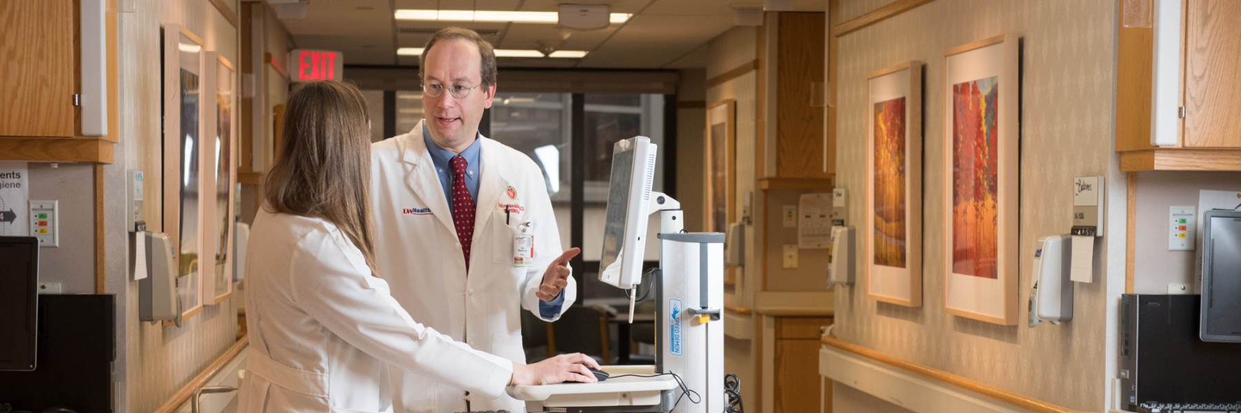 Dr. Didier Mandelbrot talking with clinical staff member in hospital corridor