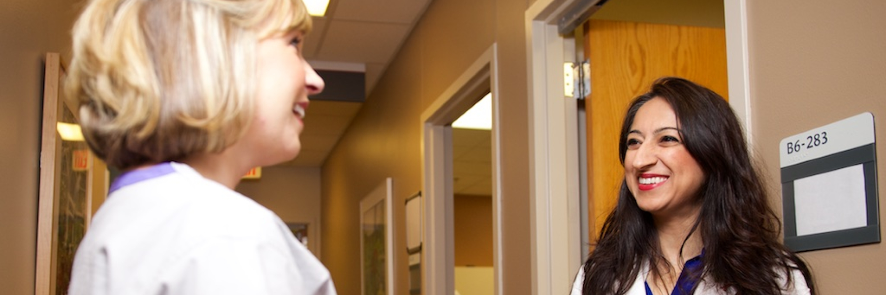 Dr. Safdar talking with colleague in clinic